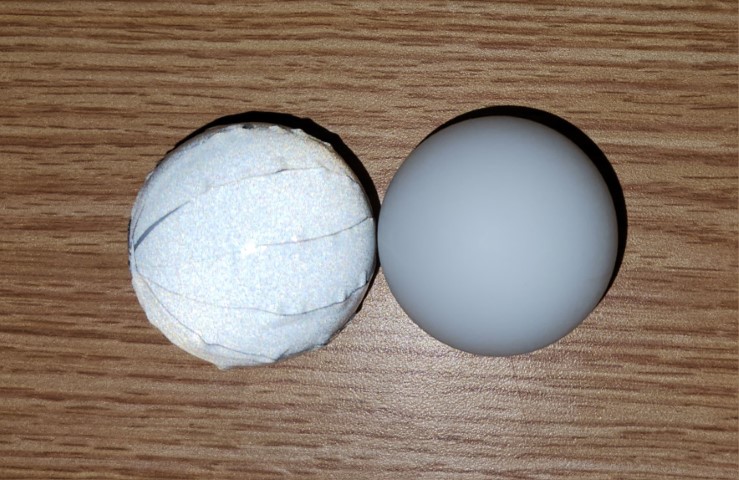 2 ping pong balls, one covered in retroreflective tape